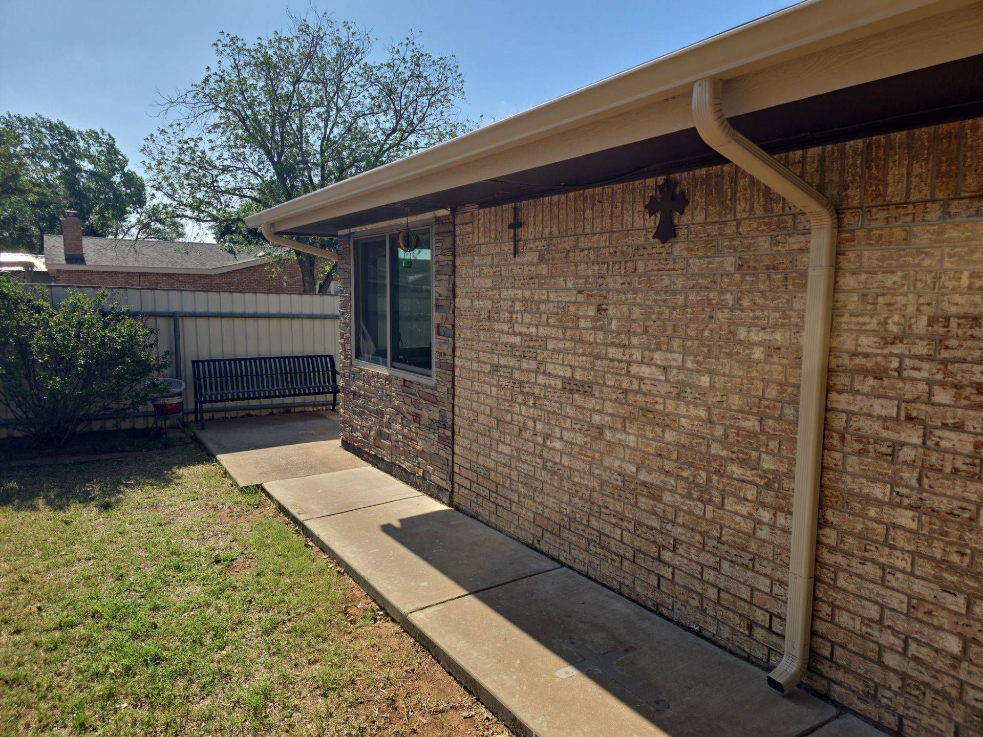 Seamless gutters and downspout on a brick home in West Texas