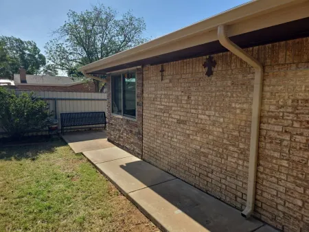 Seamless gutters and downspout on a brick home in West Texas