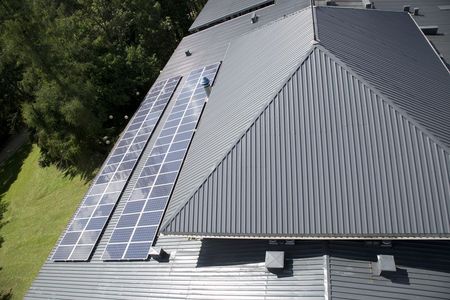 Metal roof with installed solar panel system for residential renewable energy