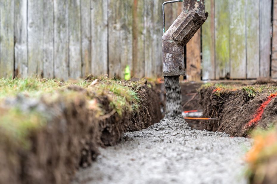 a wooden fence with a hole in the ground