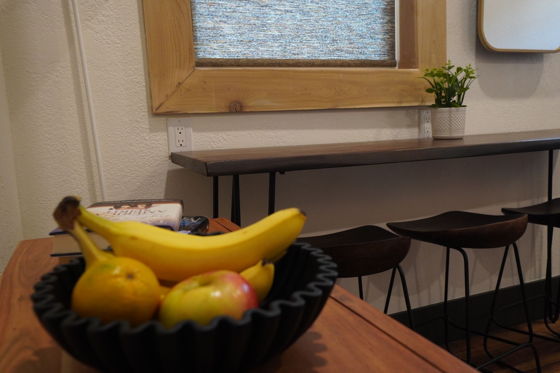 Bowl of fruit on a table with a cafe setting in the background.
