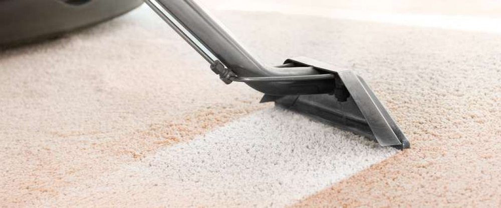 Eco Friend Carpet Clean - A carpet cleaner removes dirt from a beige carpet, leaving a clean white path.