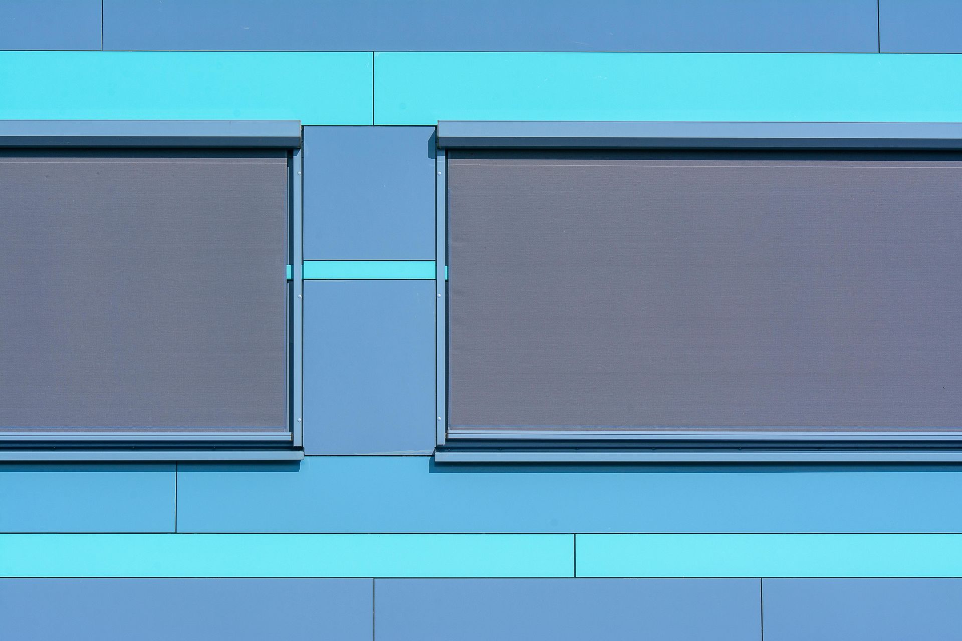 Blue wall with two dark rectangular panels and a glowing cyan horizontal light in the center