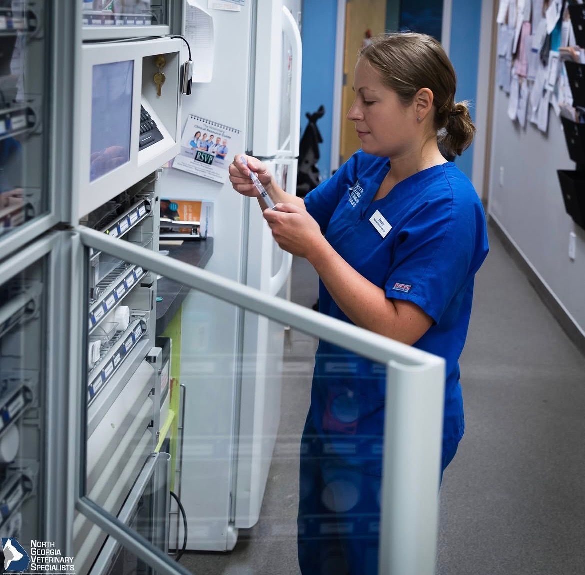 A man in a lab coat is working on a machine - Buford, GA - North Georgia Veterinary Specialists 