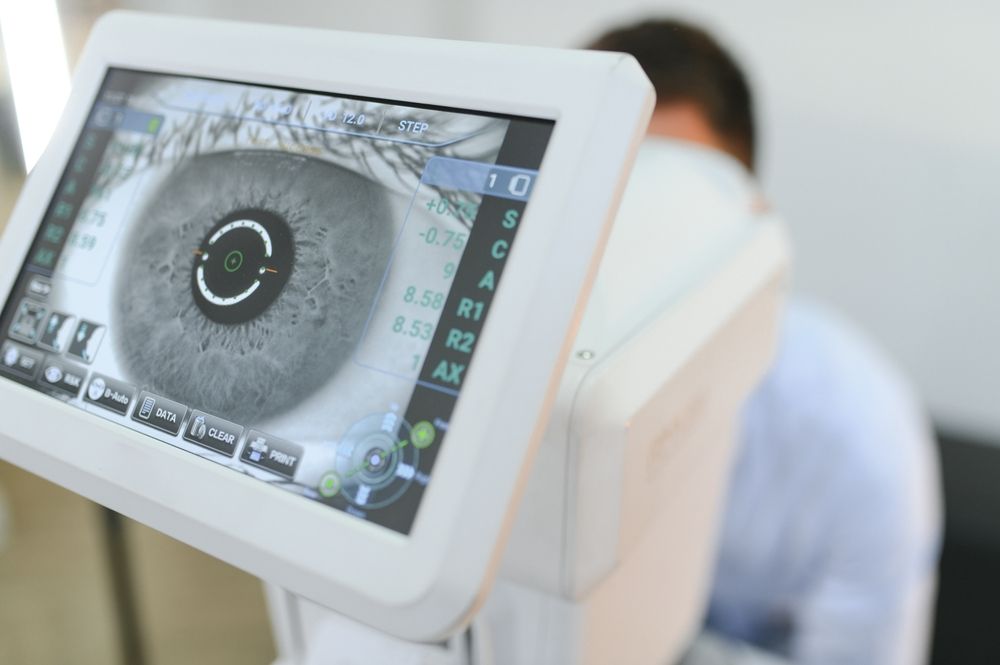 Handsome man getting an eye exam at ophthalmology clinic.