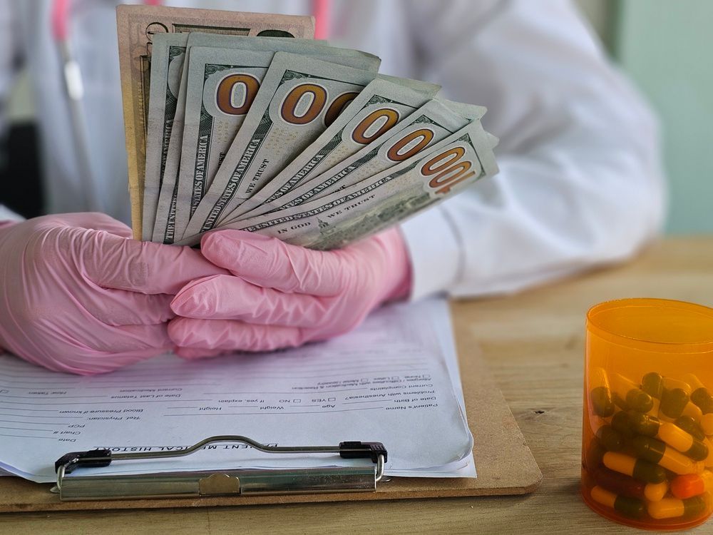 Money exchanges hands in a health related setting involving medication and financial transactions