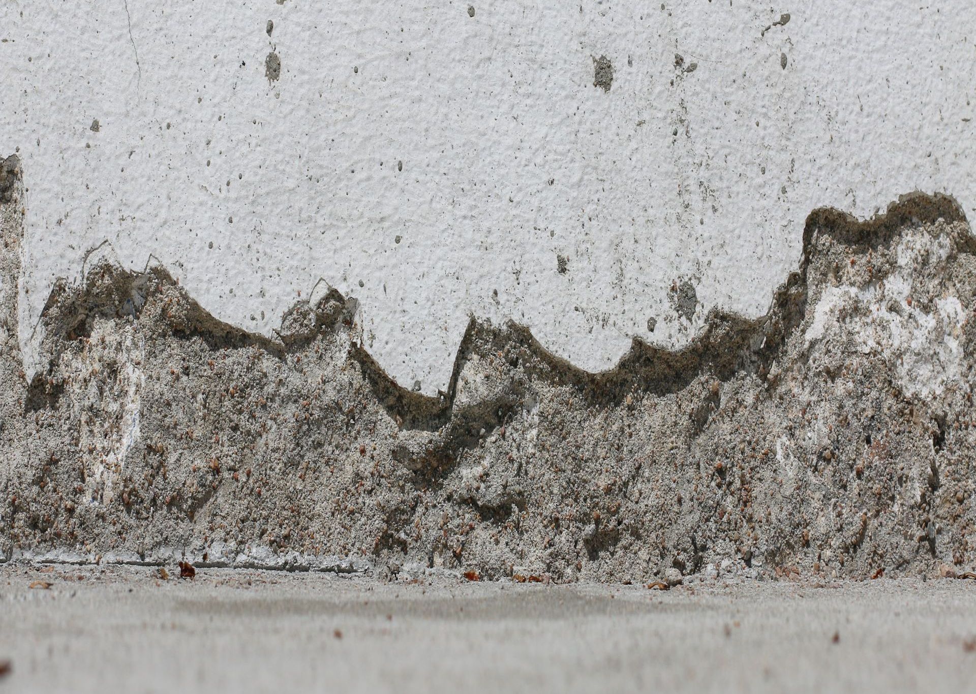 A close up of a concrete wall with a lot of dust on it