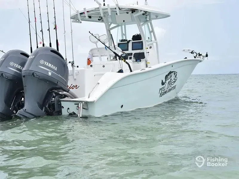 White fishing boat with twin Yamaha outboards on calm water under a pale sky.