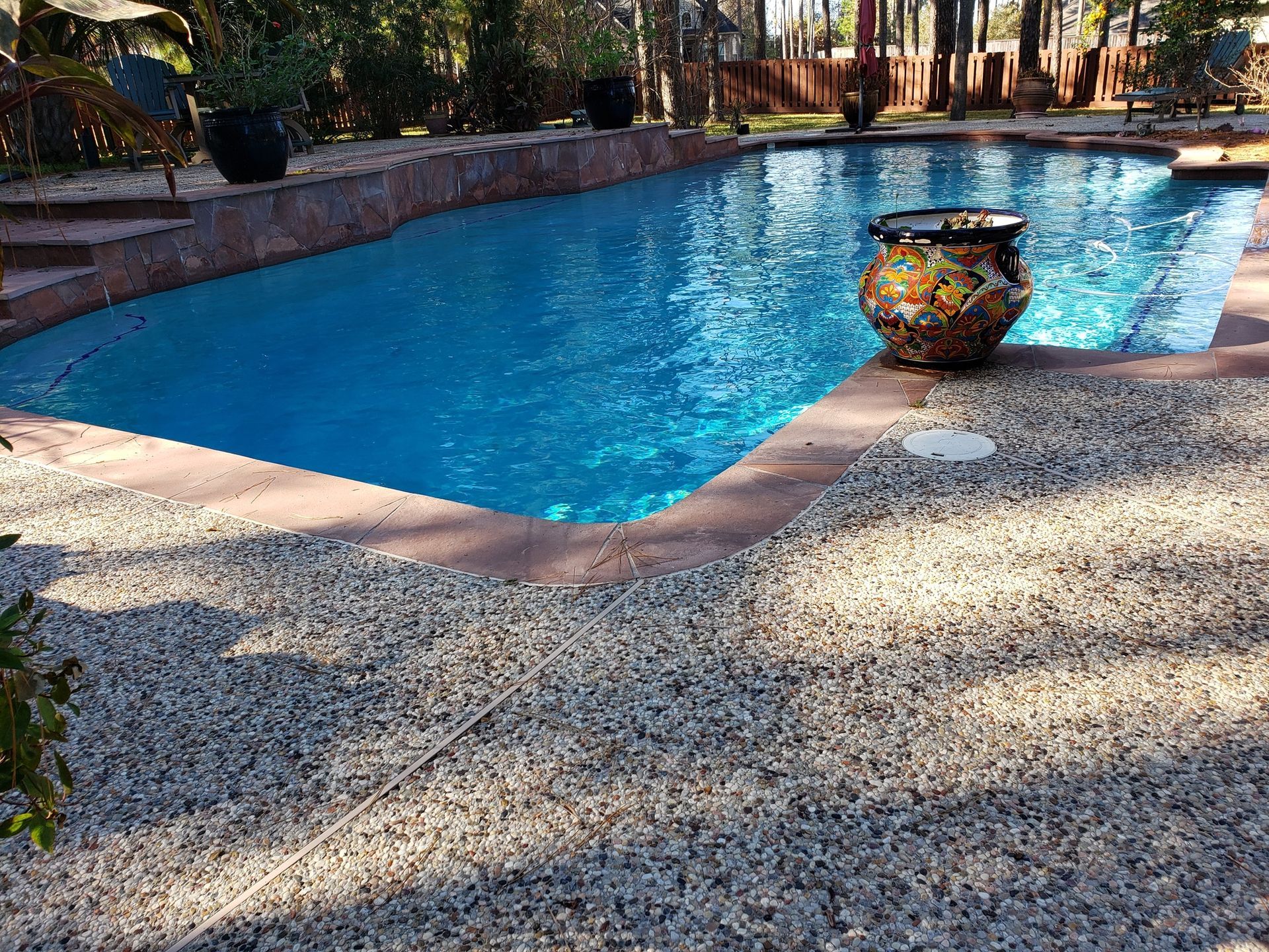 A large swimming pool with a vase in the middle of it.