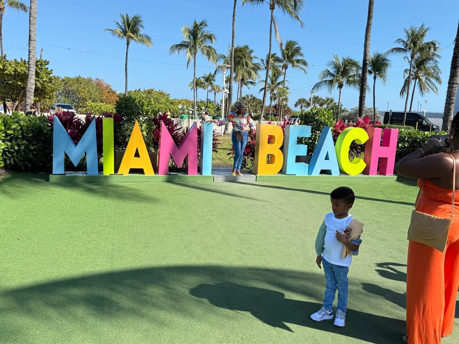 passengers-taking-group-photo-at-miami-beach-sign.jpg
