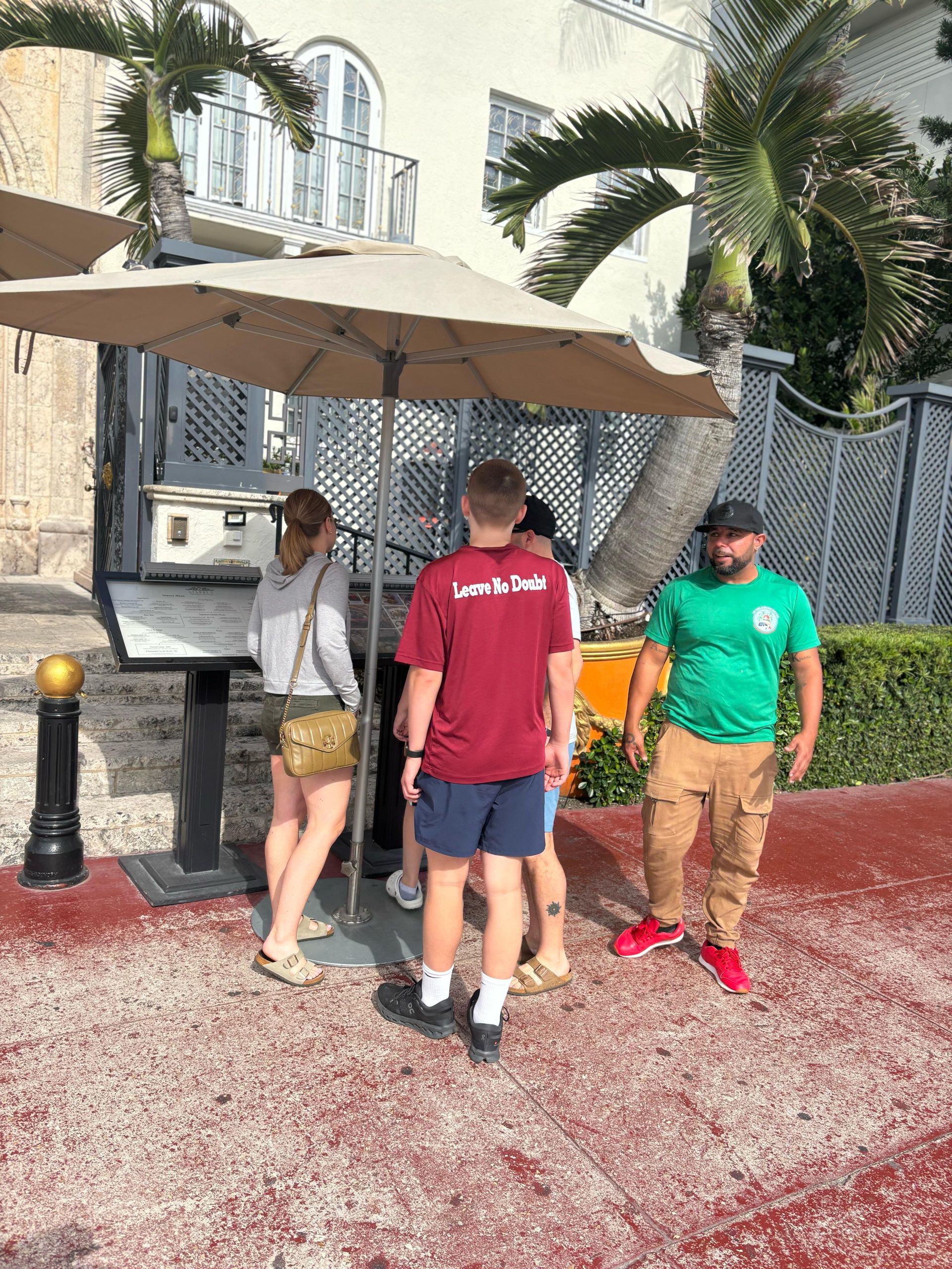 Guests learning about the Versace Mansion during South Beach walking tour on the small group Miami sightseeing tour

