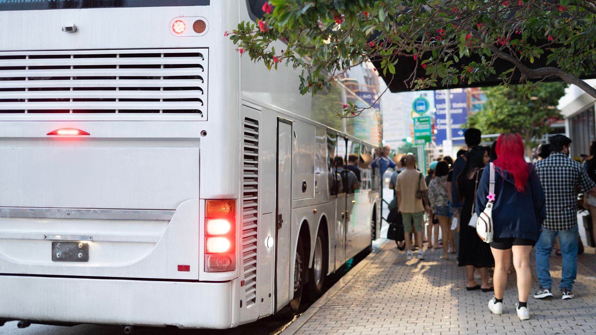 Tourists lining up for the Miami to Key West bus tour outside the bus terminal in downtown Miami
