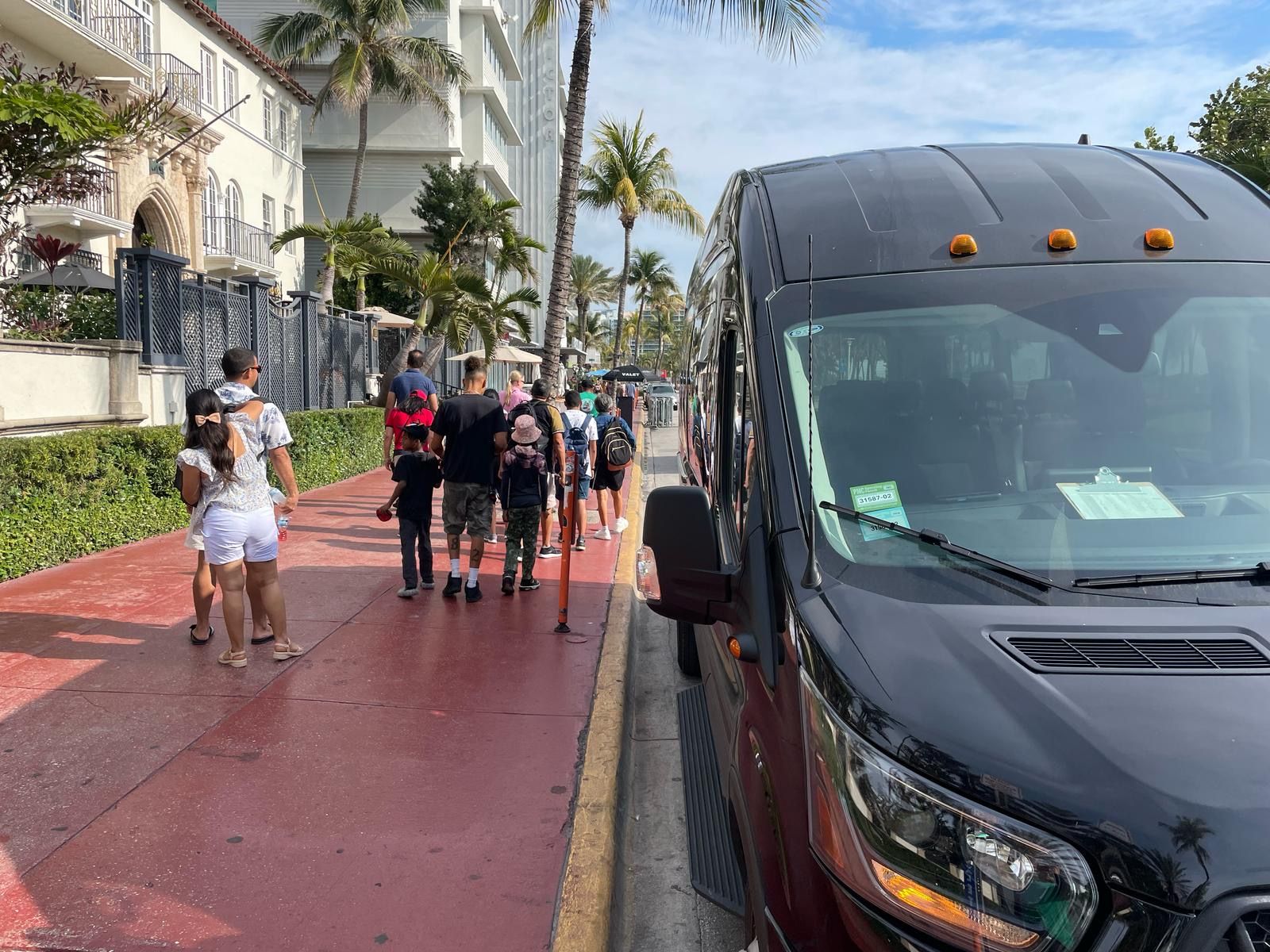 Miami tour buses in ocean drive parked in front the Versace Mansion. 