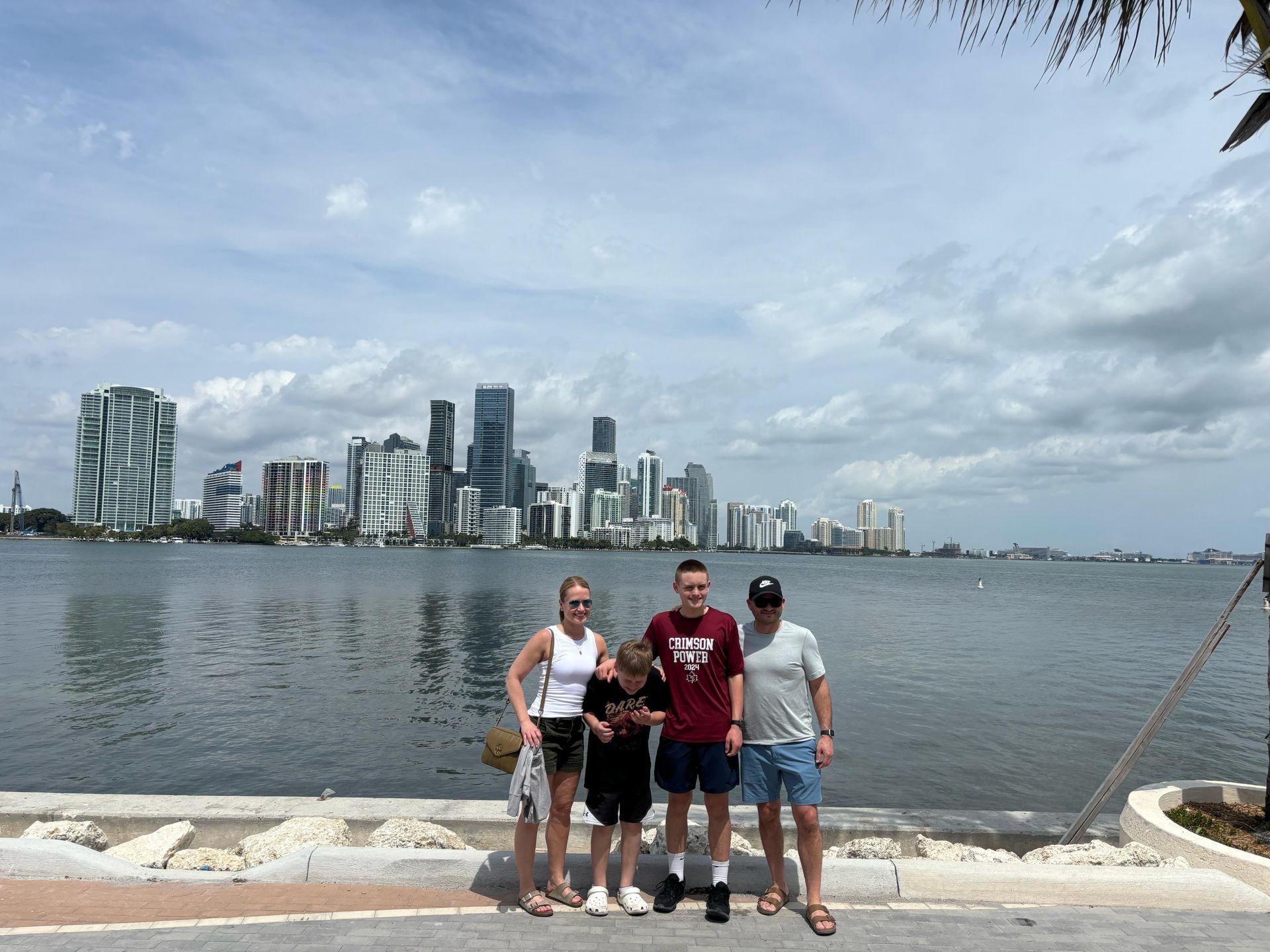 Family enjoying secret skyline photo stop with Downtown Miami backdrop on the small group Miami sightseeing tour
