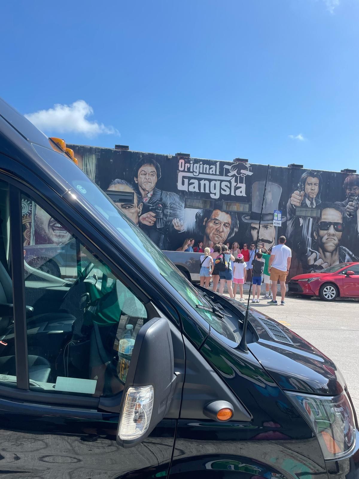 “Miami tour bus parked near the colorful Wynwood Walls street art district”
