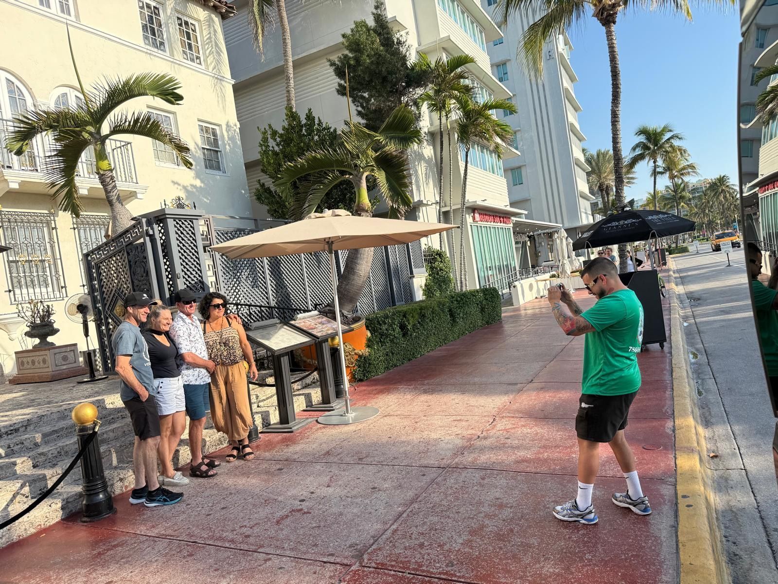 Alex the Miami Super Tour guide talking photos of passengers in front of the Versace Mansion