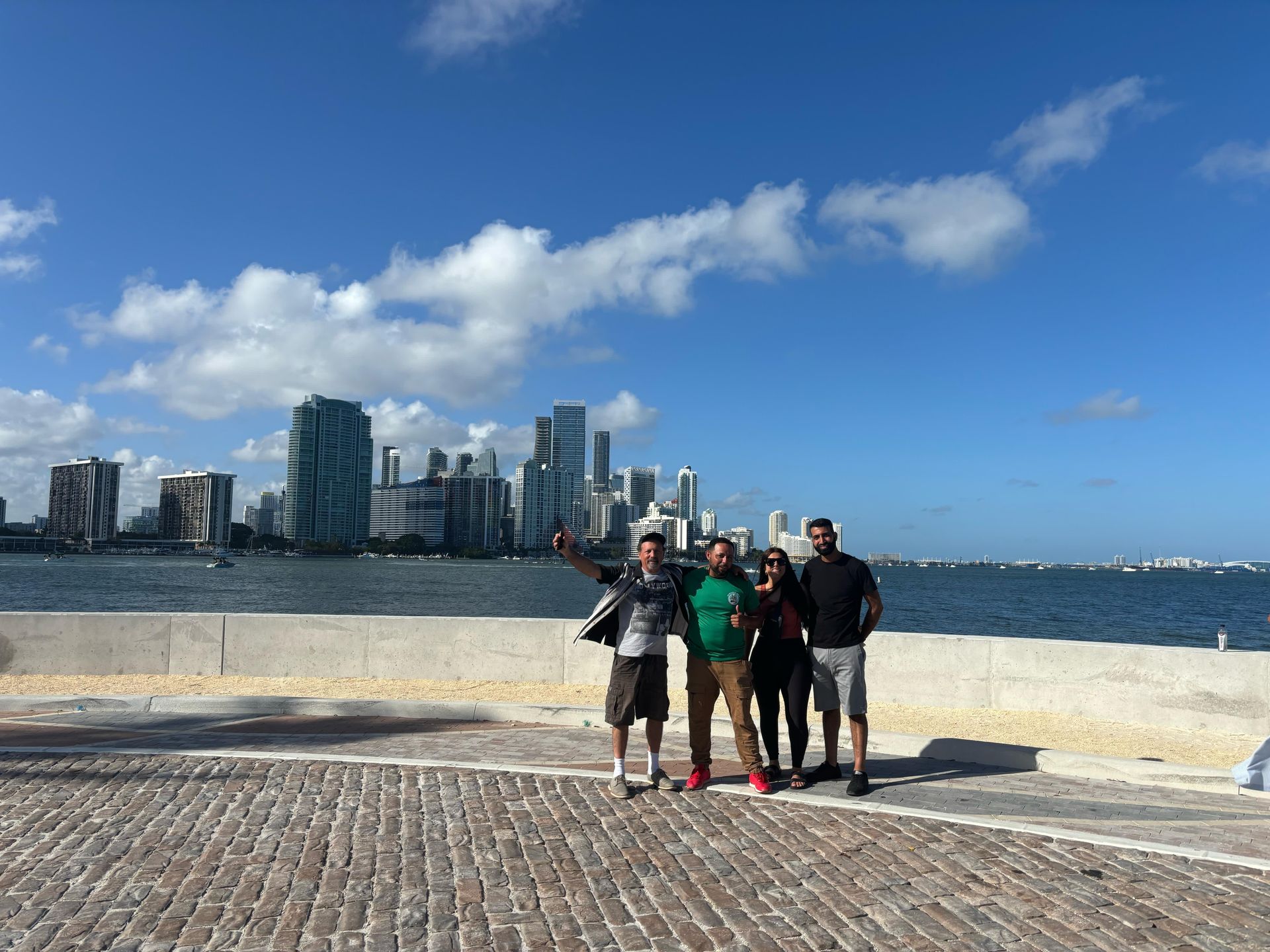passengers on the Top Miami bus tour in the Miami skyline Secret photo spot taking a selfie with the tour guide