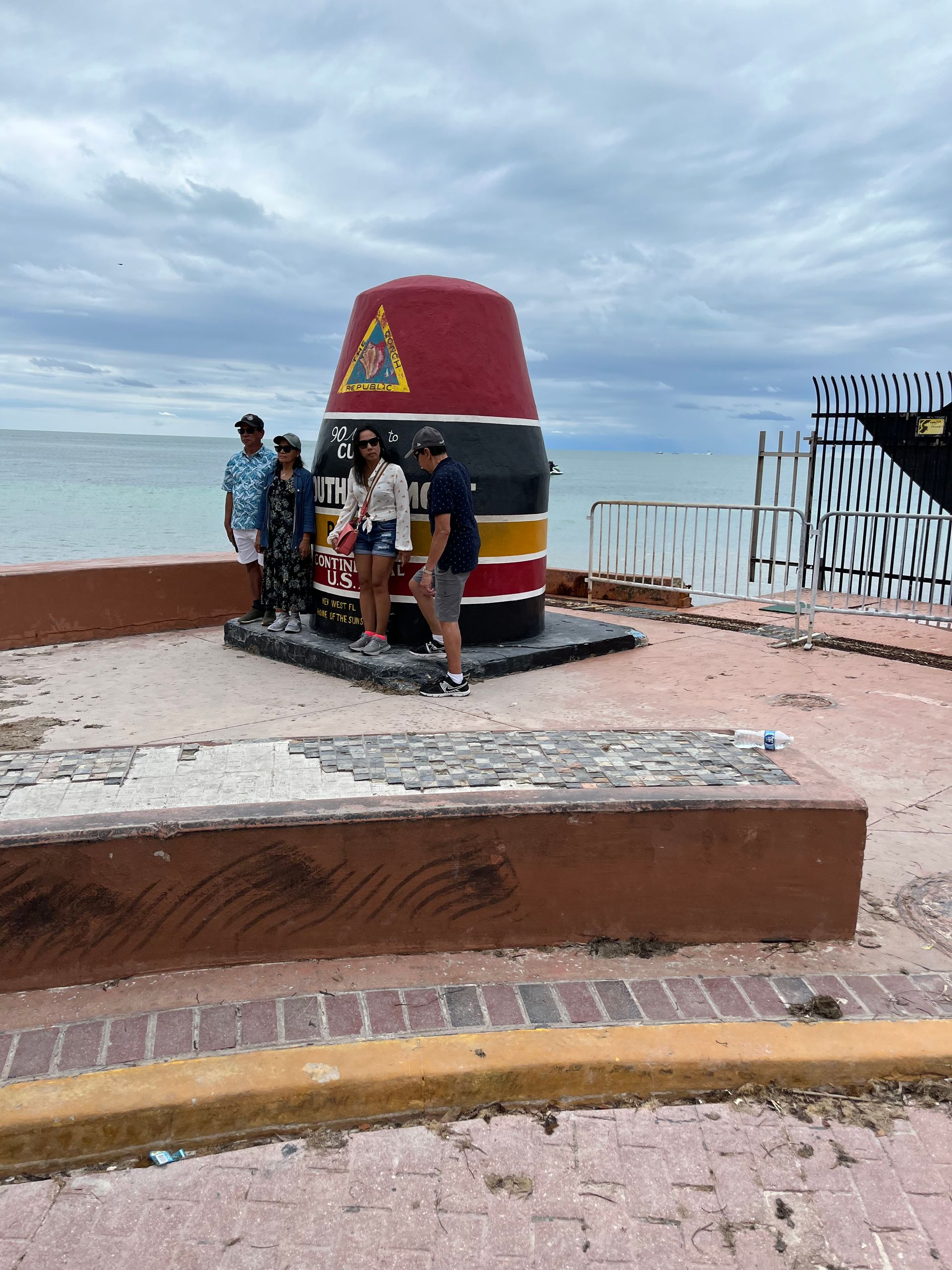 Tourists at the Southernmost Point landmark during a Miami to Key West day trip
