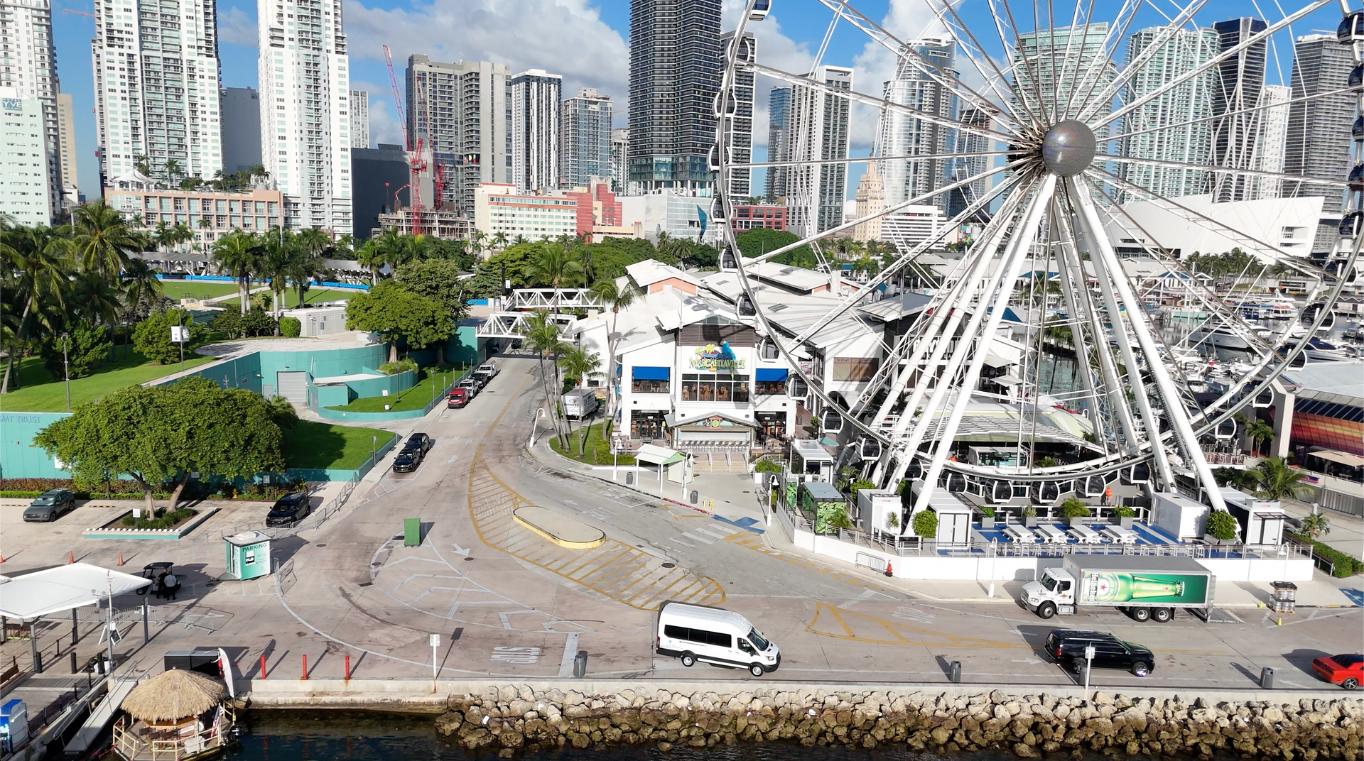 Miami city tour bus parked at Bayside near the observation wheel with skyline views