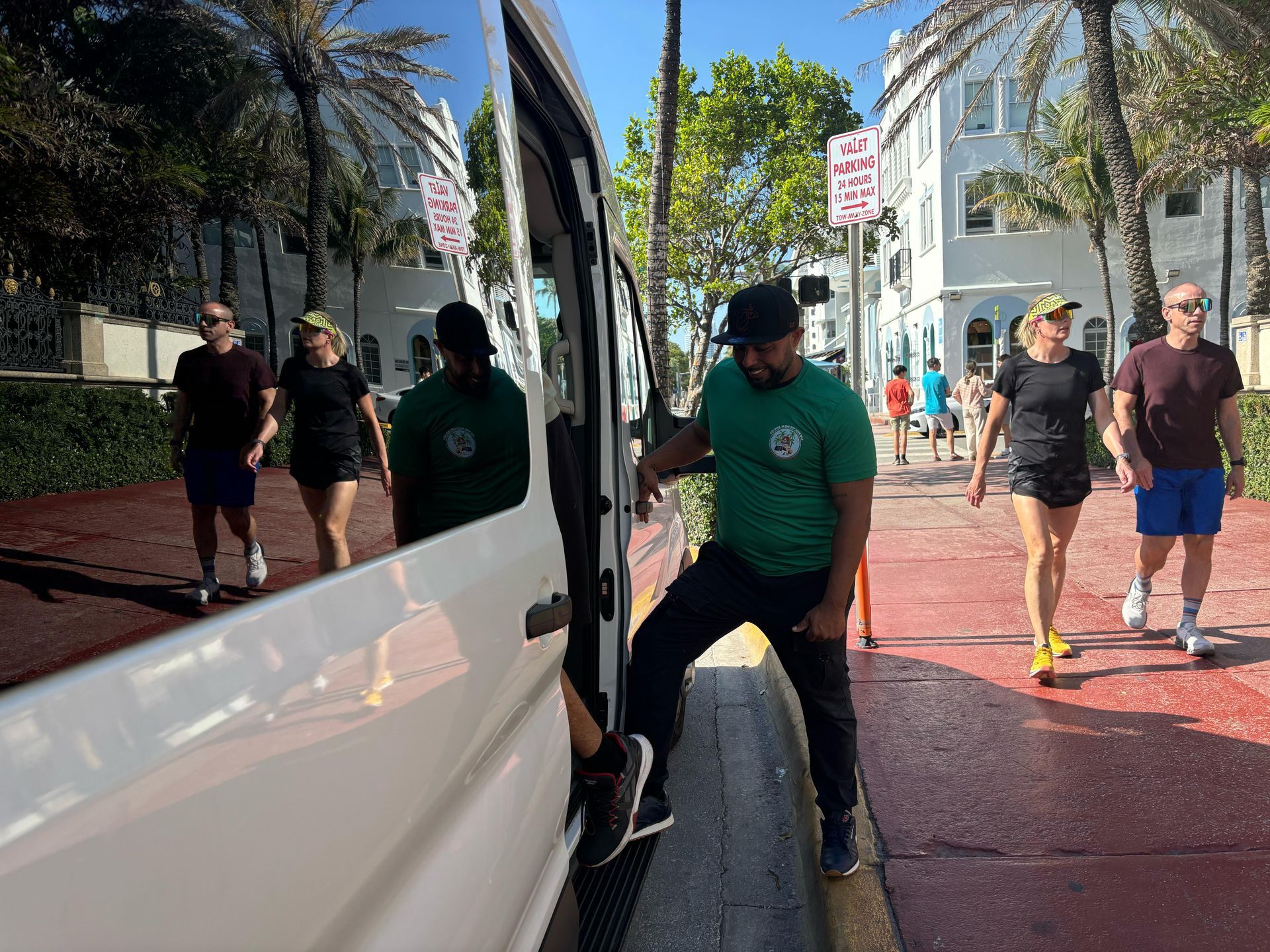 Angel the Miami Rockstar Tour guide, boarding passengers on the white Miami Tour bus