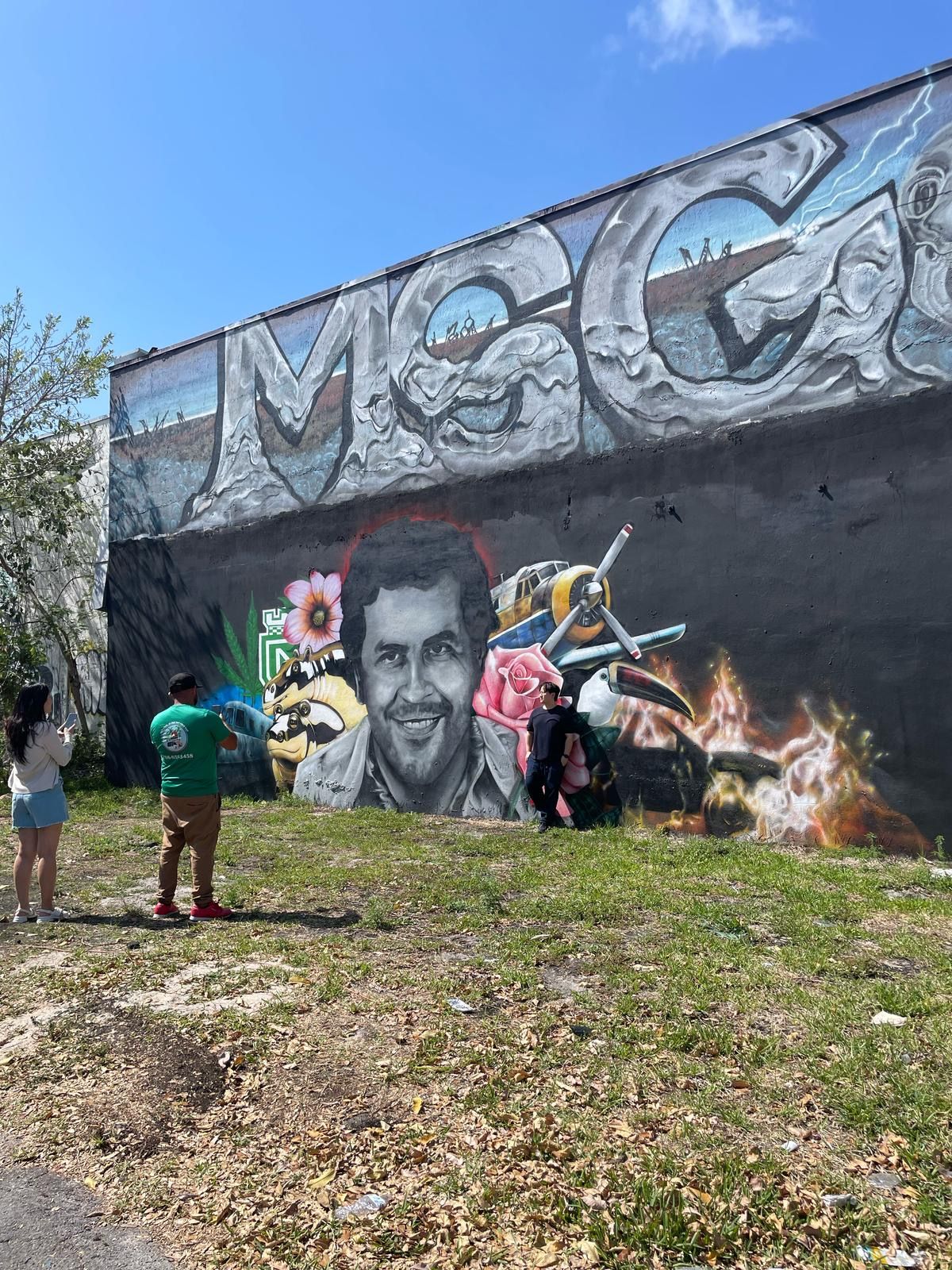 Tour guests exploring Wynwood Walls mural during Miami hop-on hop-off sightseeing bus tour
