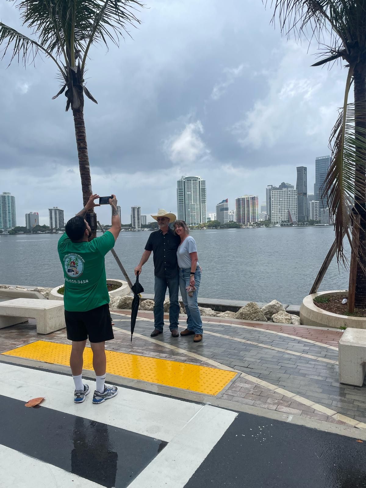Couple posing for a photo with Miami skyline during city sightseeing tour
