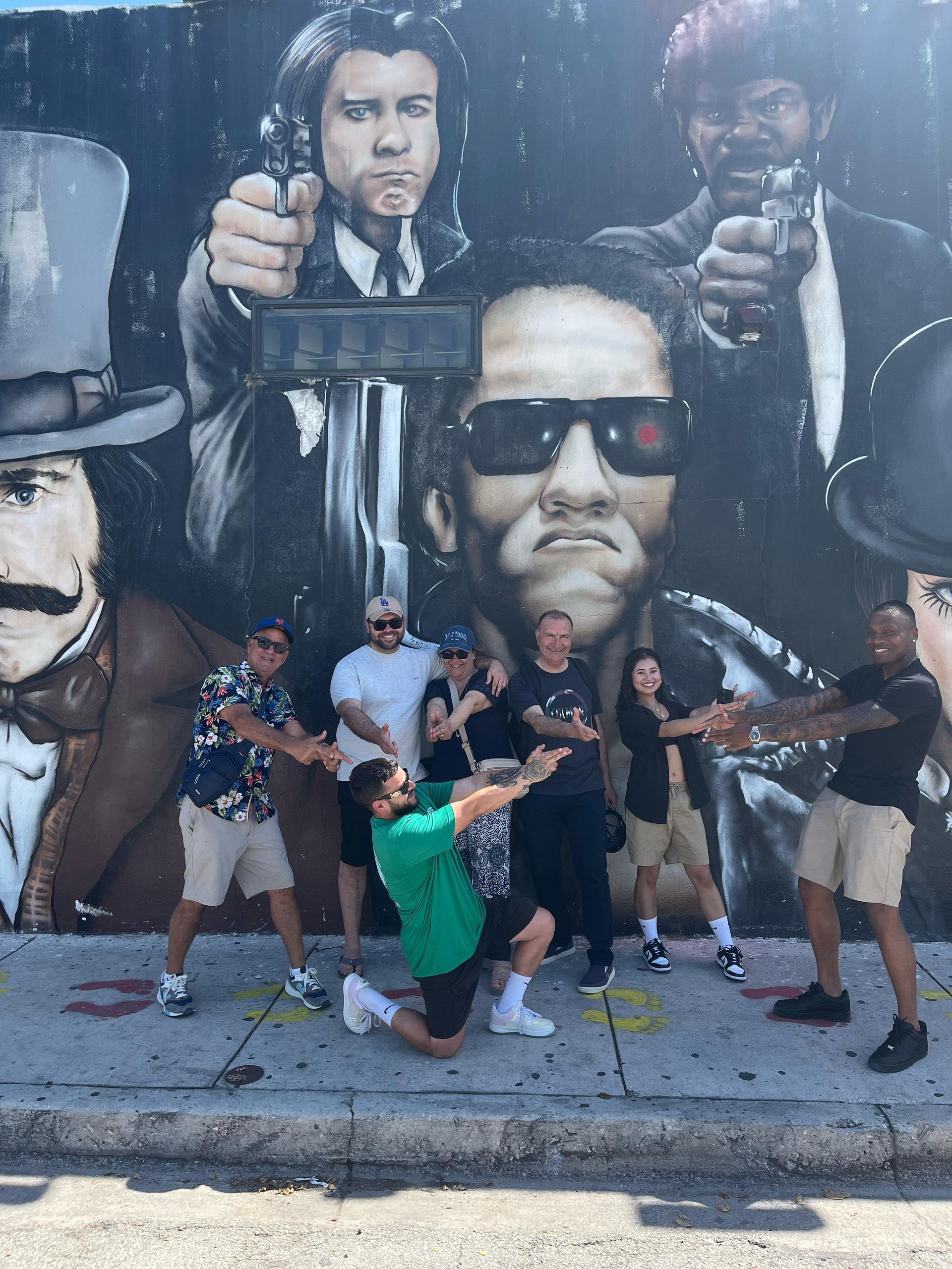 “Happy passengers snapping selfies with the tour guide at Wynwood Walls during the Miami city tour”
