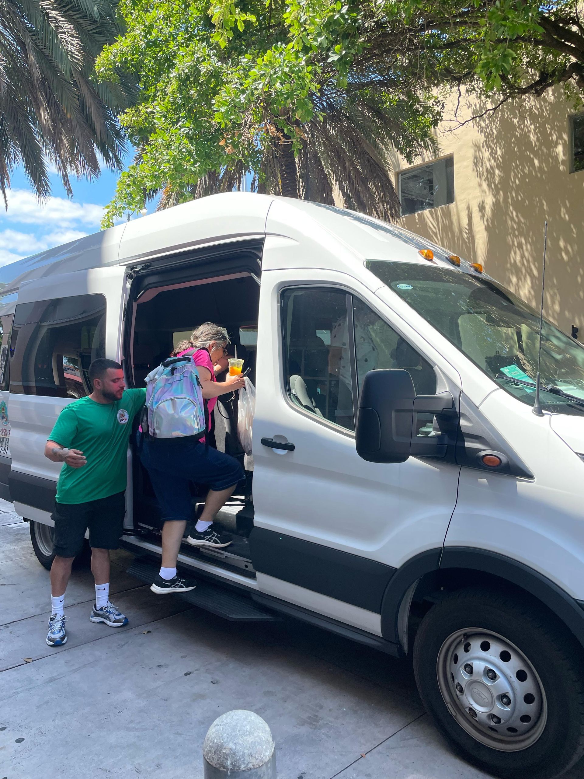 Small group waiting to board the Miami Tour Bus
