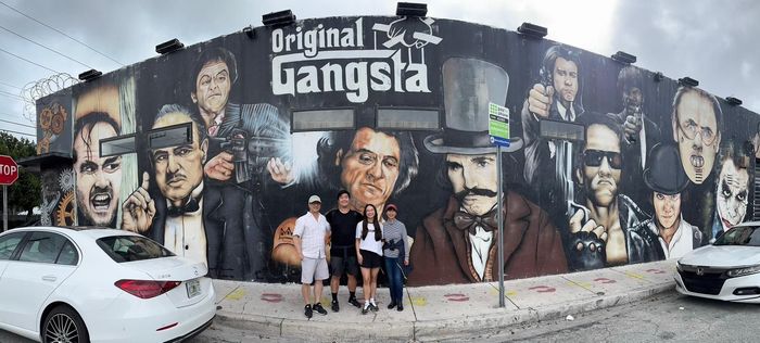 Wynwood on a Miami Bus tour passengers with the Gangster wall behind them. 