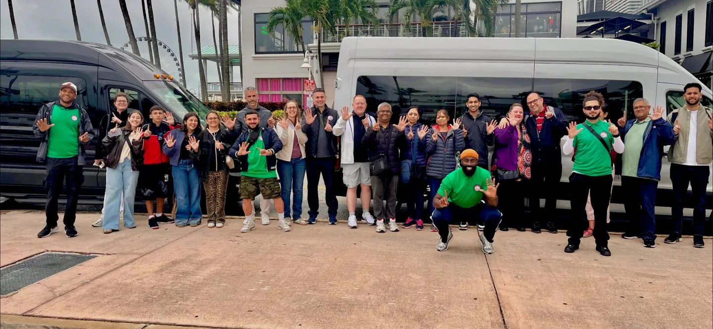 Group of guests in front of two Miami tour buses at Bayside Marketplace enjoying the Miami 5-in-1 city tour experience.