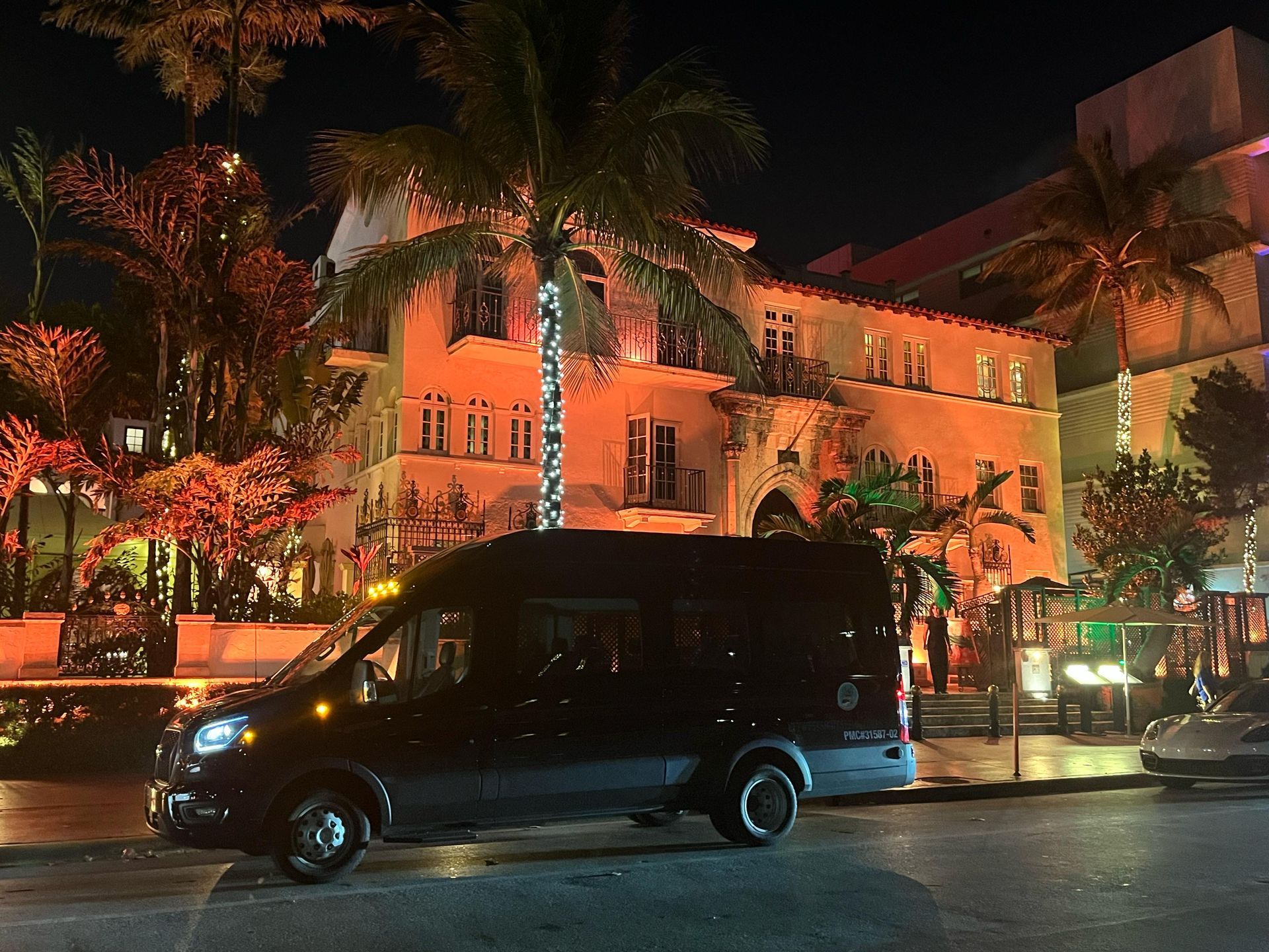 Miami hop on hop off at. night parked in the Versace Mansion