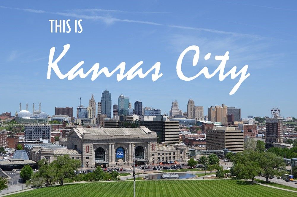 Kansas City skyline with the city name overlaid on a blue sky.
