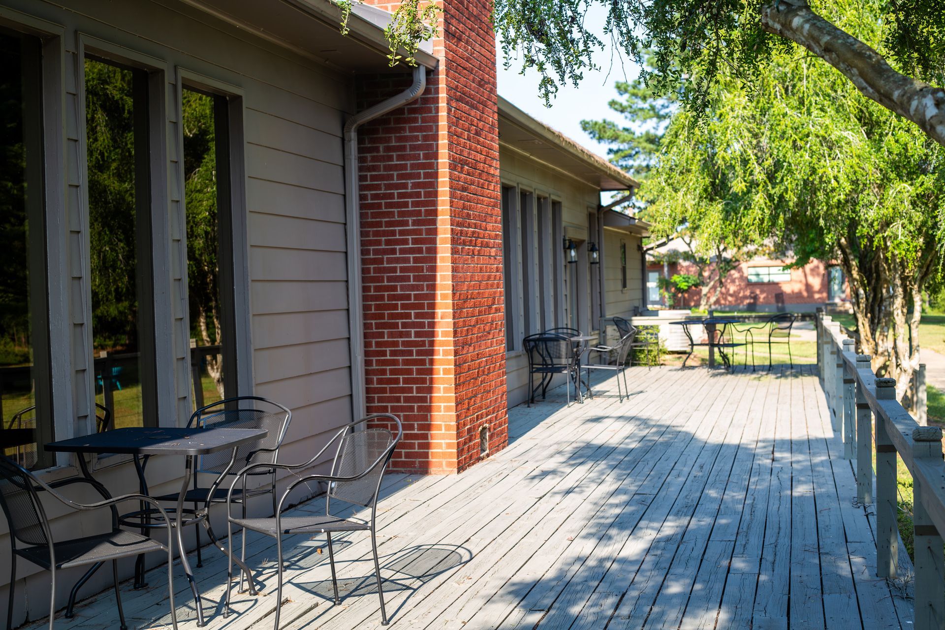 A brick house with a brown roof and a walkway leading to it