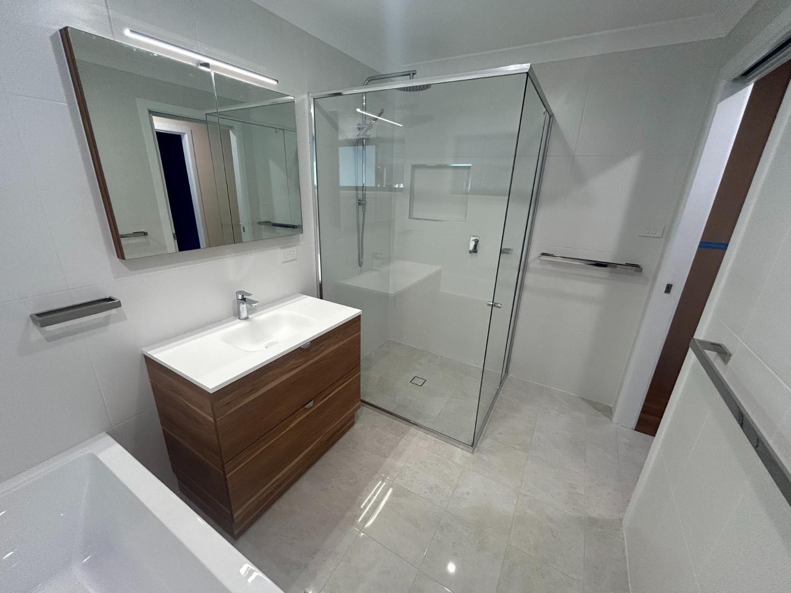 A Bathroom With a Sink , Mirror and Walk in Shower — BK Build Group in Bellingen, NSW