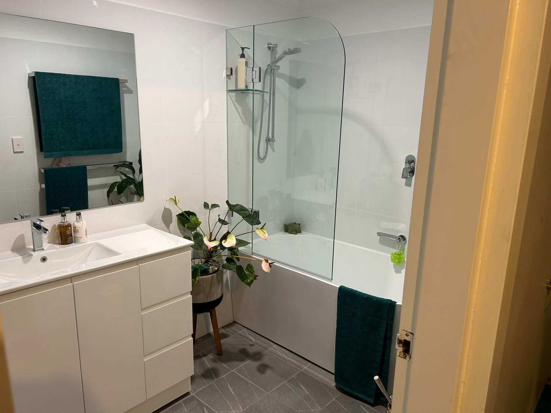 A Bathroom With a Sink , Tub , Shower and Mirror — BK Build Group in Sawtell, NSW
