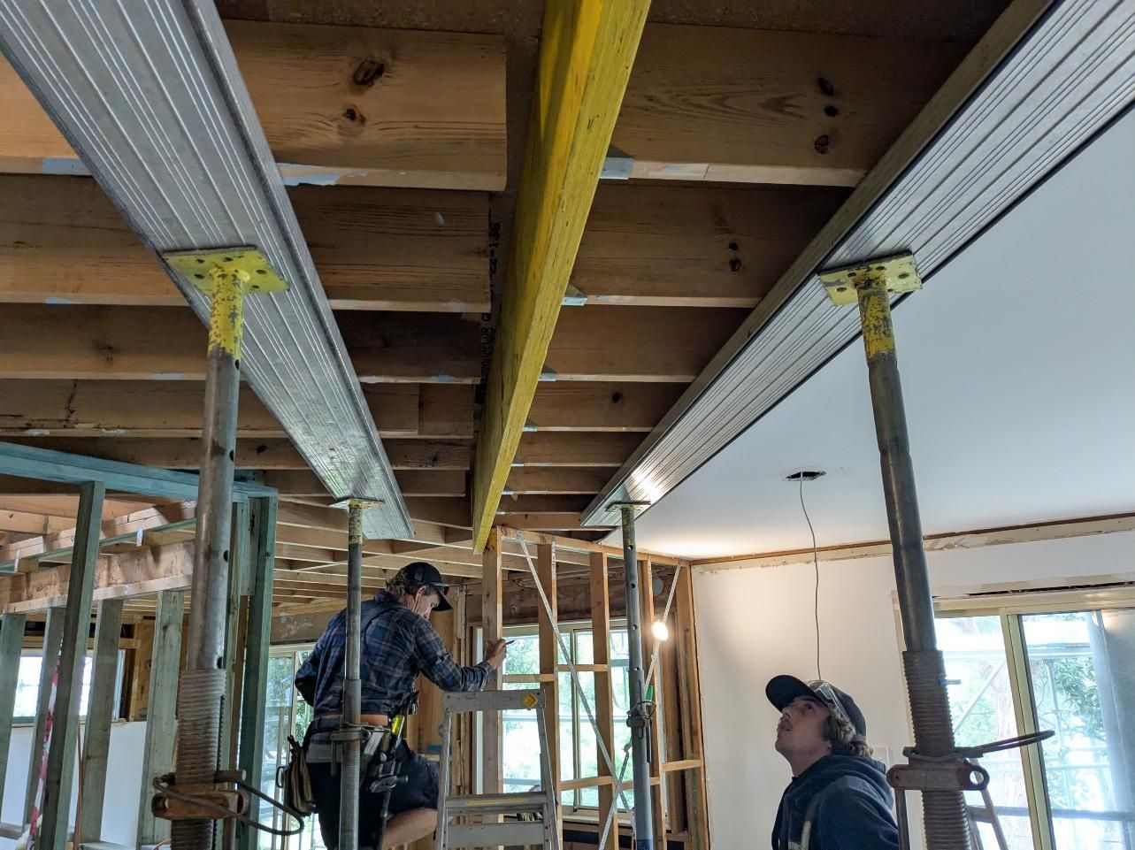 Two Men Are Working on the Ceiling of a Building — BK Build Group in Sawtell, NSW