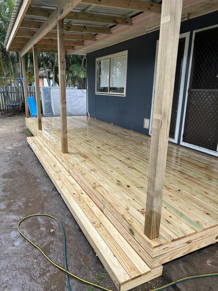 A Wooden Deck is Being Built on the Side of a House — BK Build Group in Woolgoolga, NSW