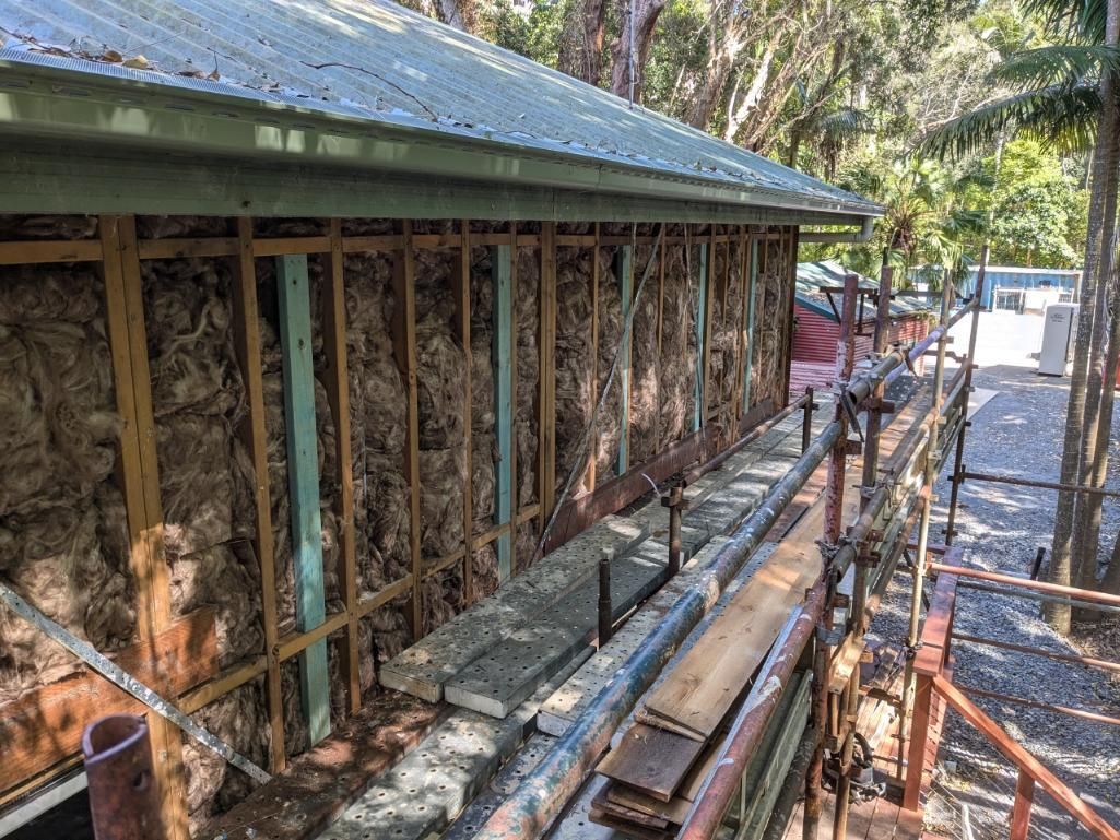 A House is Being Built With Wooden Beams and a Metal Roof — BK Build Group in Bellingen, NSW
