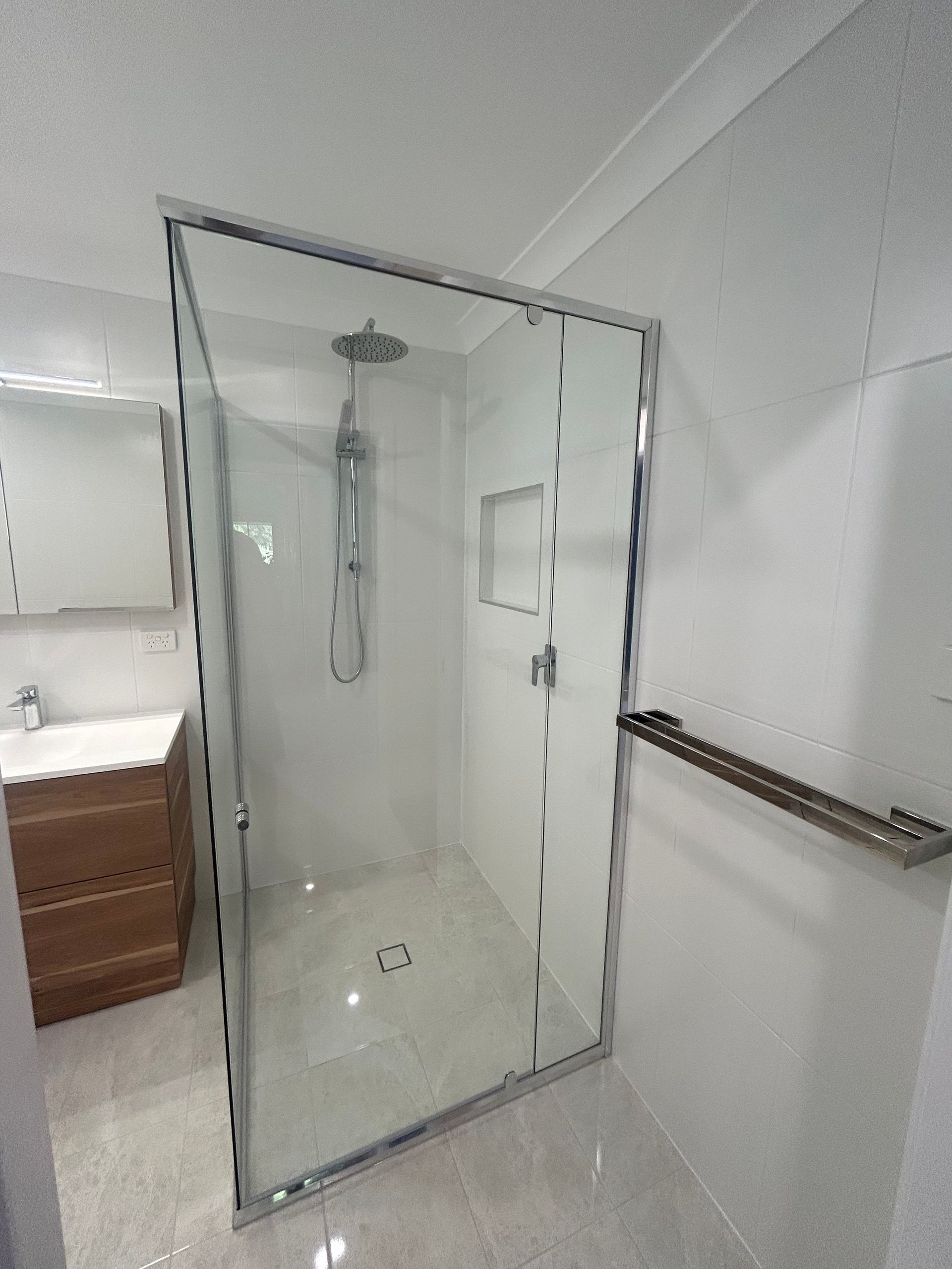 A Bathroom With a Walk in Shower and a Sink — BK Build Group in Coffs Harbour, NSW