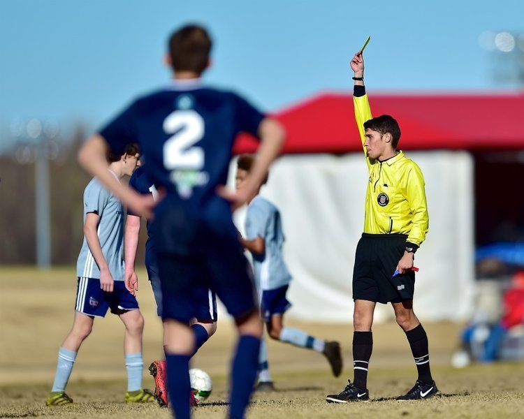 Referee issuing a card