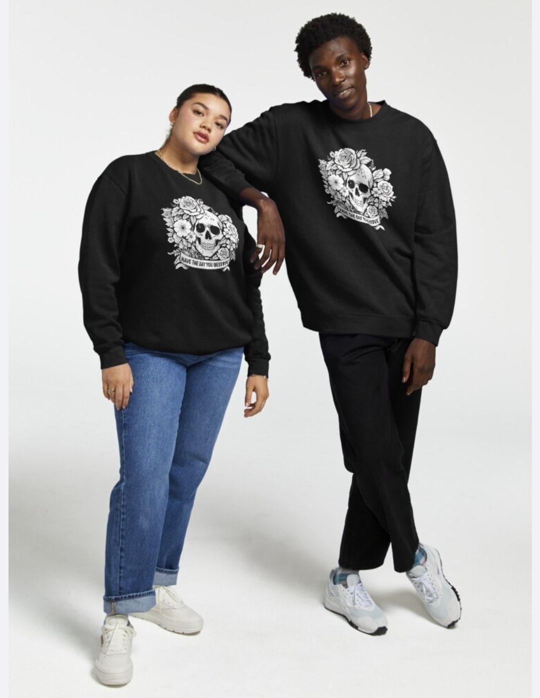 Two models wearing black graphic sweatshirts, jeans, and sneakers pose against a white studio background.
