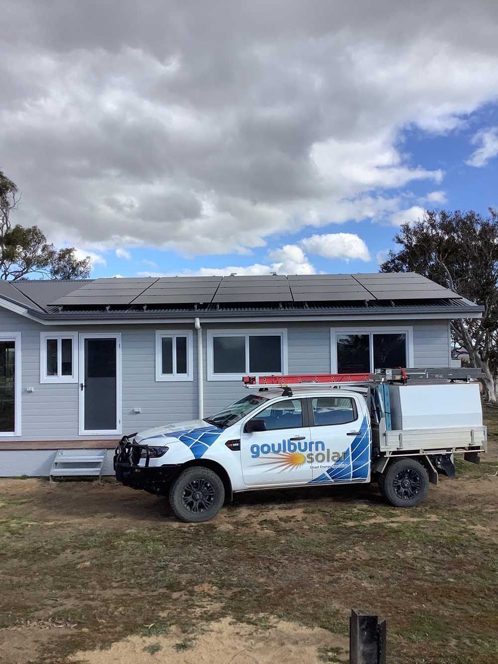Truck Parked In Front Of A House With Solar Panels On The Roof — Goulburn Solar In Goulburn, NSW