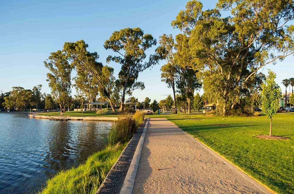 Path Leading To A Lake Surrounded By Trees And Grass — Goulburn Solar In Goulburn, NSW