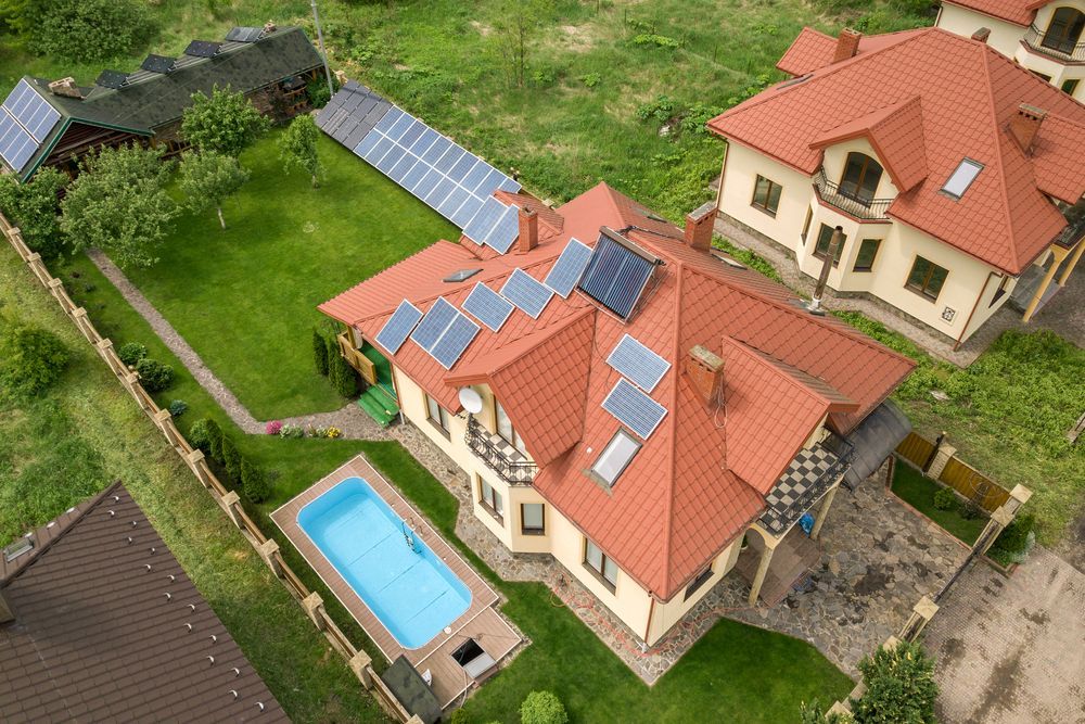House With Red Roof, Solar Panels, Swimming Pool, and a Fenced Yard — Goulburn Solar In Gungahlin, ACT