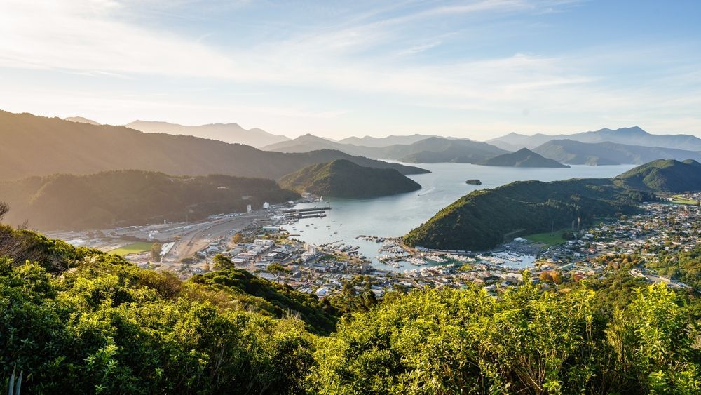 Aerial View Of A City Surrounded By Mountains And A Body Of Water — Goulburn Solar In Picton, NSW