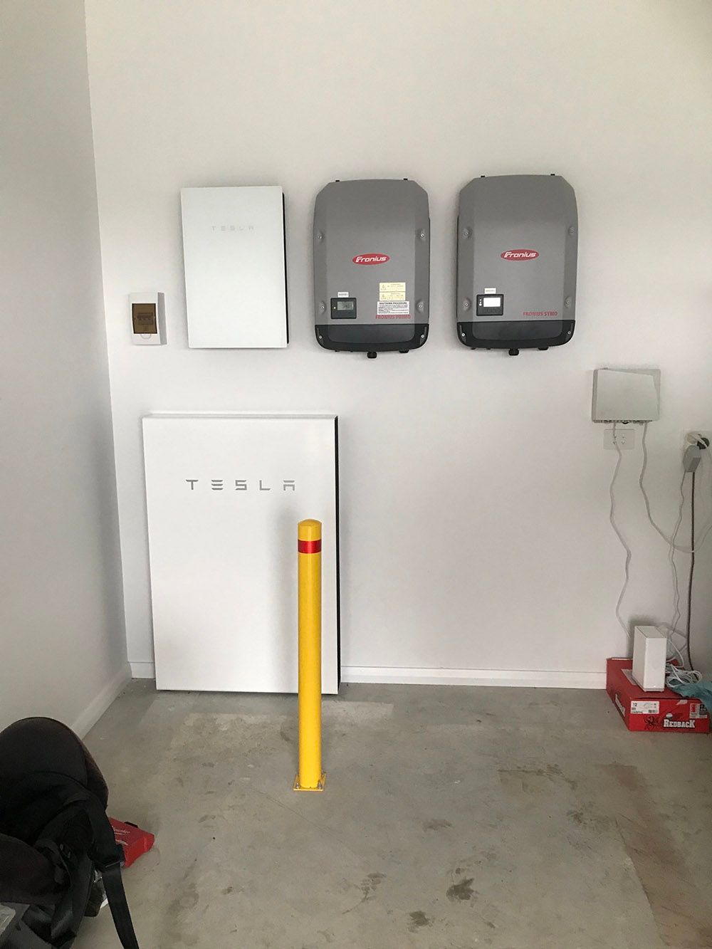 Room With A Tesla Battery And Two Solar Panels On The Wall — Goulburn Solar In Goulburn, NSW