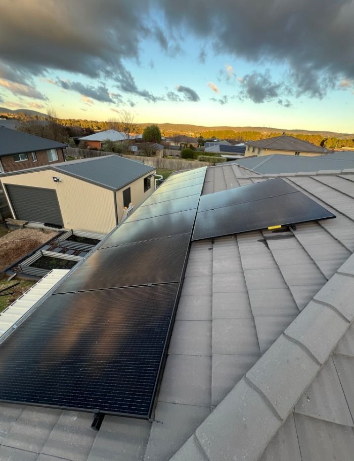 An Aerial View Of A House With Solar Panels On The Grey Roof — Goulburn Solar In Goulburn, NSW