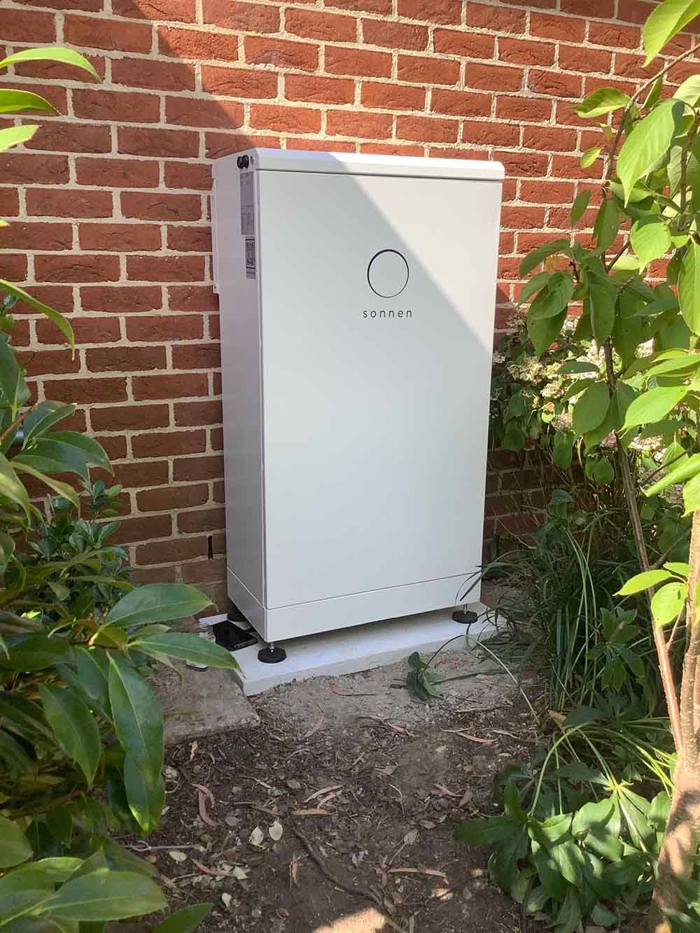 White Sonnen On The Ground In Front Of A Brick Wall — Goulburn Solar In Goulburn, NSW