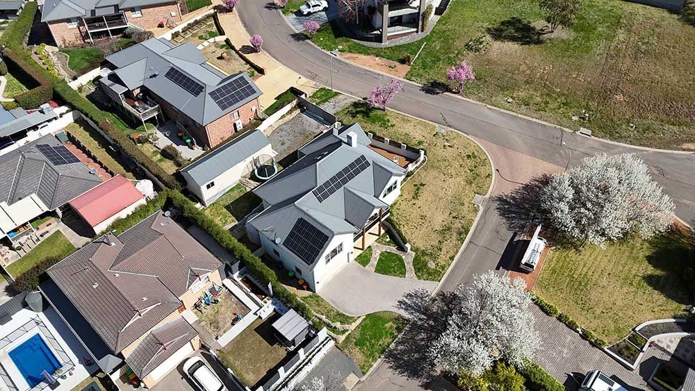 Aerial View Of A Residential Area With Lots Of Houses And Solar Panels — Goulburn Solar In Bega, NSW