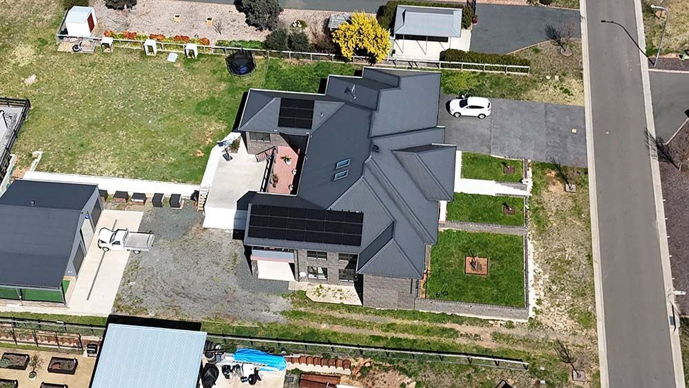 Aerial View Of A Modern House With Solar Panels — Goulburn Solar In Marulan, NSW